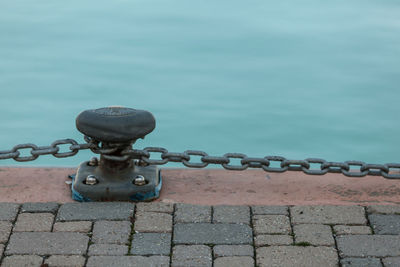 Close-up of chain against wall