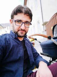 Portrait of man crouching outdoors