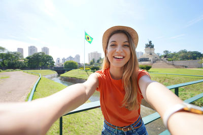 Tourism in sao paulo. beautiful smiling girl takes self portrait in sao paulo, brazil.