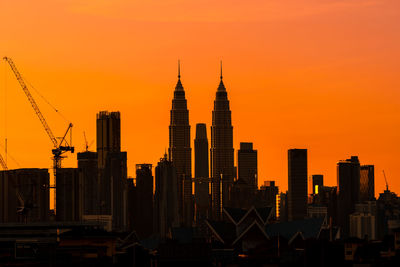 Modern buildings against sky during sunset