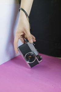 Close-up of woman holding camera