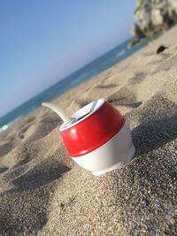 Close-up of bottle on beach