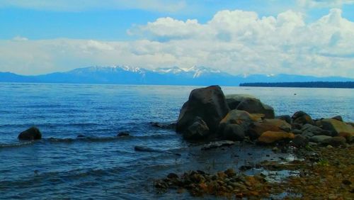 Scenic view of sea against cloudy sky