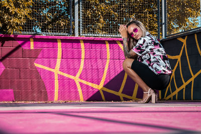 Rear view of woman sitting on street