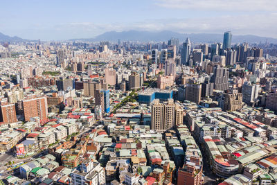 High angle view of modern buildings in city against sky