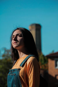 Portrait of woman against blue sky