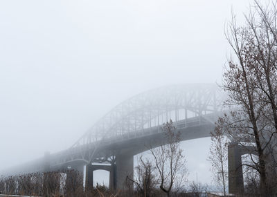 View of arch bridge against sky during winter