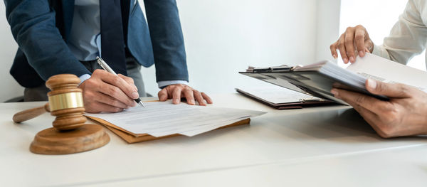 Midsection of business colleagues working on table