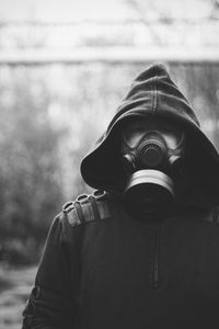 Man wearing gasmask standing outdoors