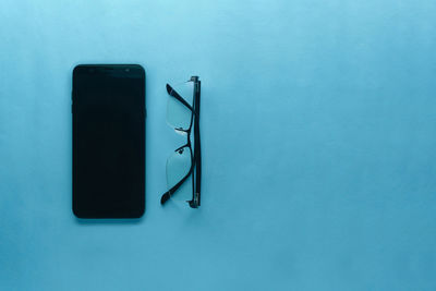 High angle view of pen on table against blue background