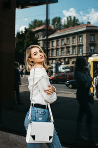 Full length of woman standing on street in city