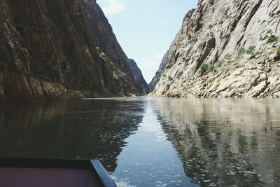 Scenic view of lake by mountains against sky at  dark canyon 