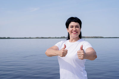 Portrait of smiling man standing in lake