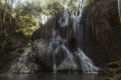 Man is climbing on waterfall