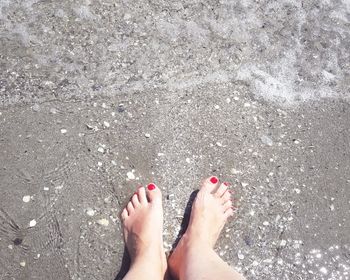 Low section of woman on sand