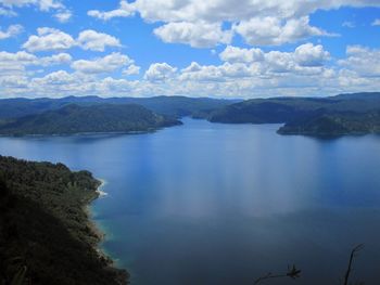 Scenic view of lake and mountains against sky