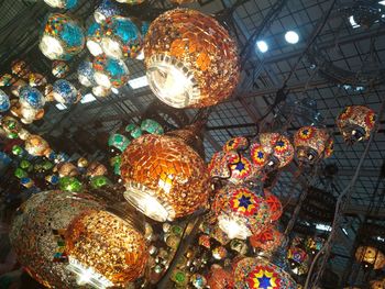 Low angle view of illuminated lighting equipment hanging on ceiling