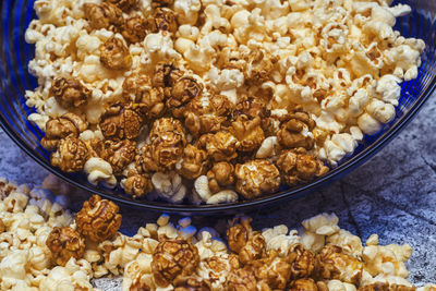 Sweet and salty popcorn in a glass bowl on an abstract background