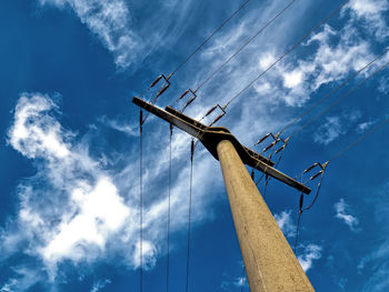 Low angle view of electricity pylon against sky