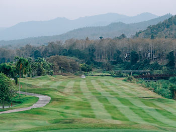 Scenic view of golf course against sky