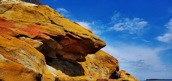 Low angle view of rock formations against sky