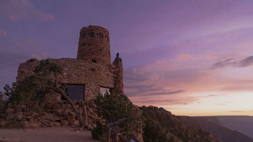 Old building against sky during sunset