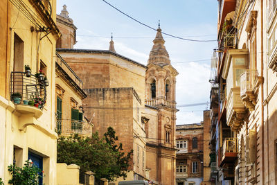 Low angle view of buildings in city against sky