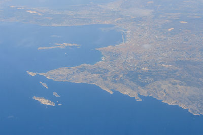 Aerial view of land and sea against sky