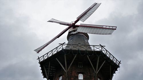 Low angle view of traditional windmill against sky