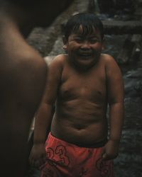 Portrait of shirtless man standing outdoors