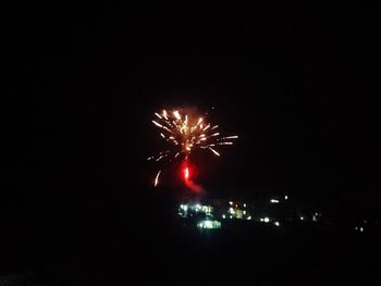 Low angle view of firework display at night