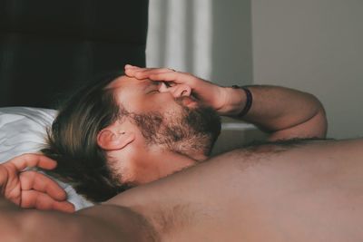 Bearded man sleeping on bed