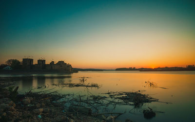 Scenic view of sea against clear sky during sunset