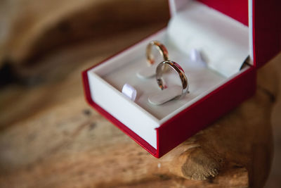 Close-up of wedding rings on wooden table