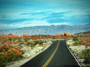 Road amidst mountains against sky