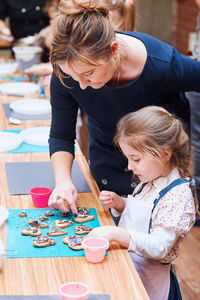 Mother and daughter on table