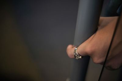 Close-up of hand holding metal pole
