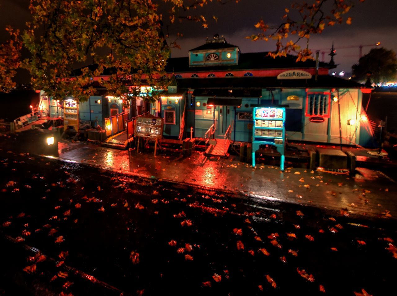 night, illuminated, transportation, building exterior, city, architecture, street, mode of transportation, built structure, road, no people, motor vehicle, land vehicle, car, outdoors, nature, wet, building, sign, lighting equipment, rain, nightlife