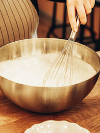 Cropped hand of person preparing food on table