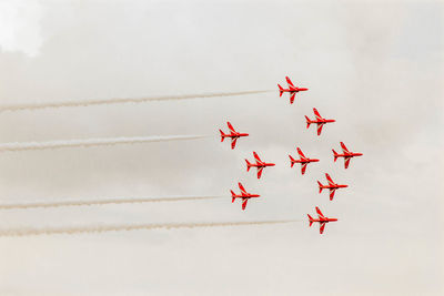 Low angle view of airplane flying against sky