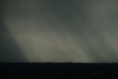 Silhouette landscape against sky during foggy weather