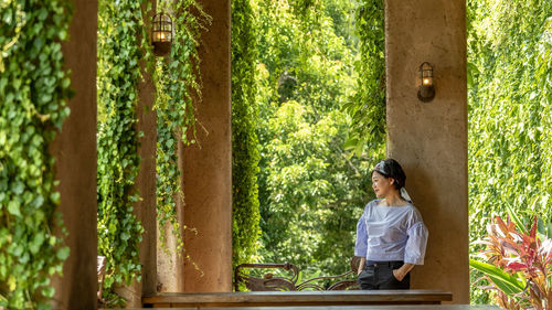 Full length of woman relaxing in forest