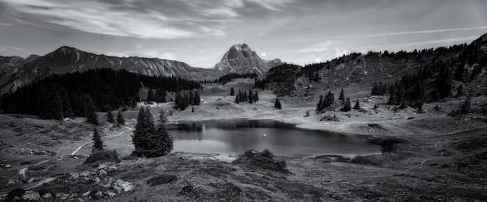 Scenic view of lake and mountains against sky