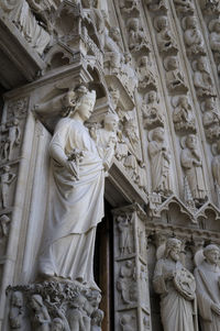 Low angle view of statue against historic building