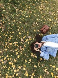 High angle view of woman lying on field