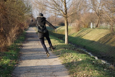 Full length of woman walking on footpath