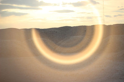 Scenic view of desert against sky during sunset