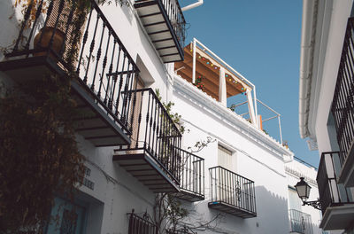 Low angle view of staircase by building against sky