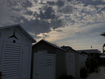 Residential buildings against sky during sunset