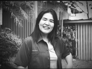Portrait of smiling young woman standing outdoors